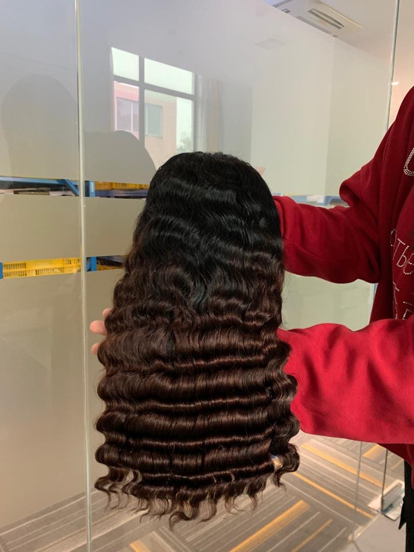 A woman is combing her hair with a comb.