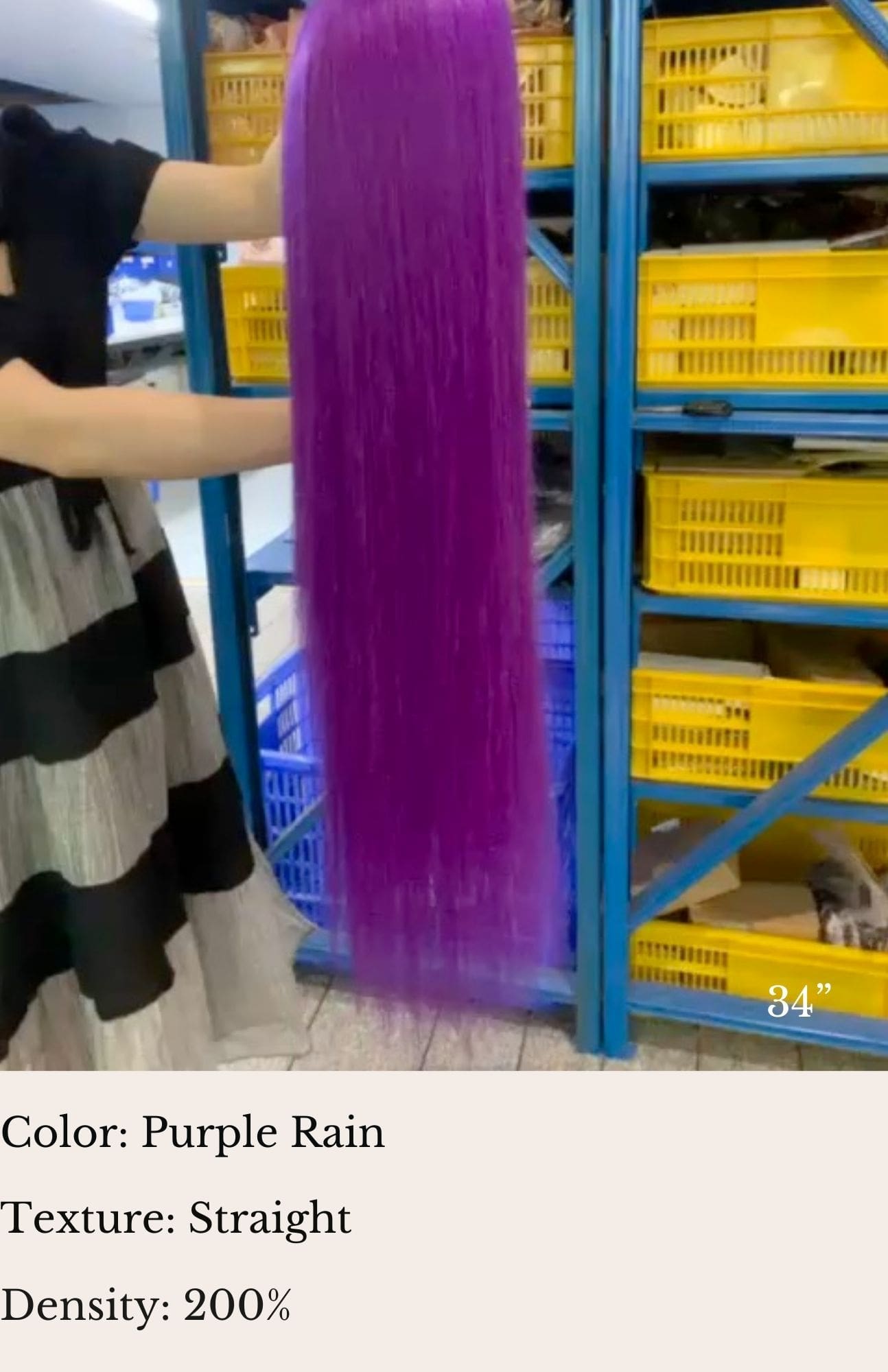 A woman holding up purple plastic in front of yellow crates.